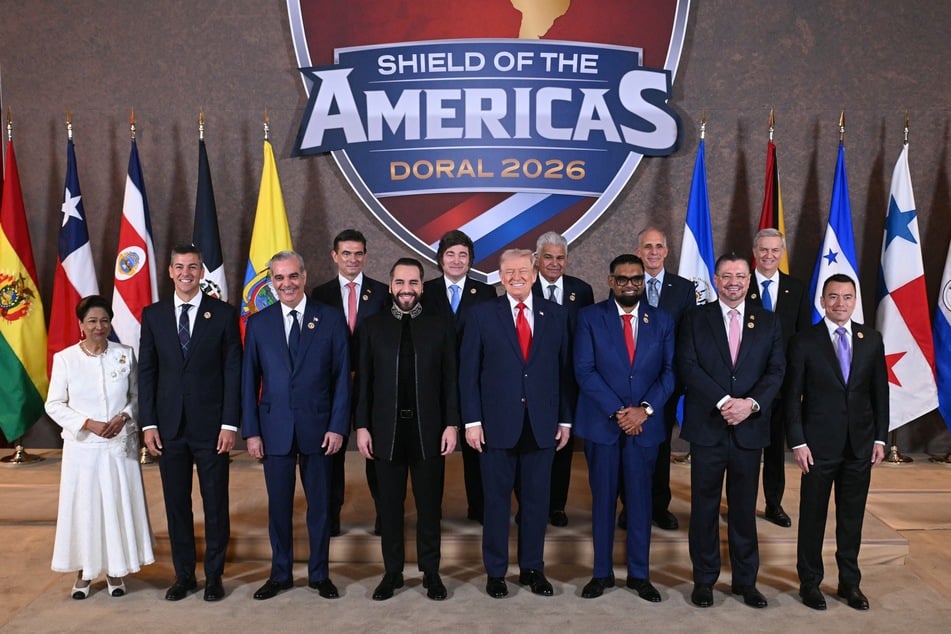 President Donald Trump (C) stands with a number of Latin American leaders during the "Shield of the Americas" Summit in Miami, Florida on March 7, 2026.