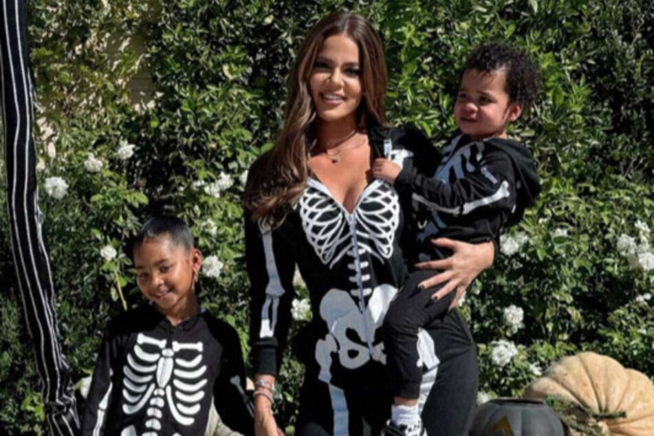 Khloé Kardashian (c.) continued her spooky season tradition by hosting her annual pumpkin-decoration bash.