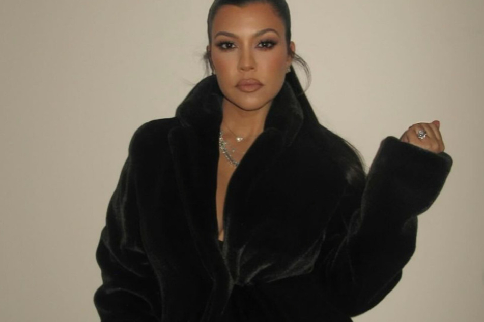 Kourtney Kardashian rocked a large fuzzy coat for the annual Kar-Jenner Christmas bash.