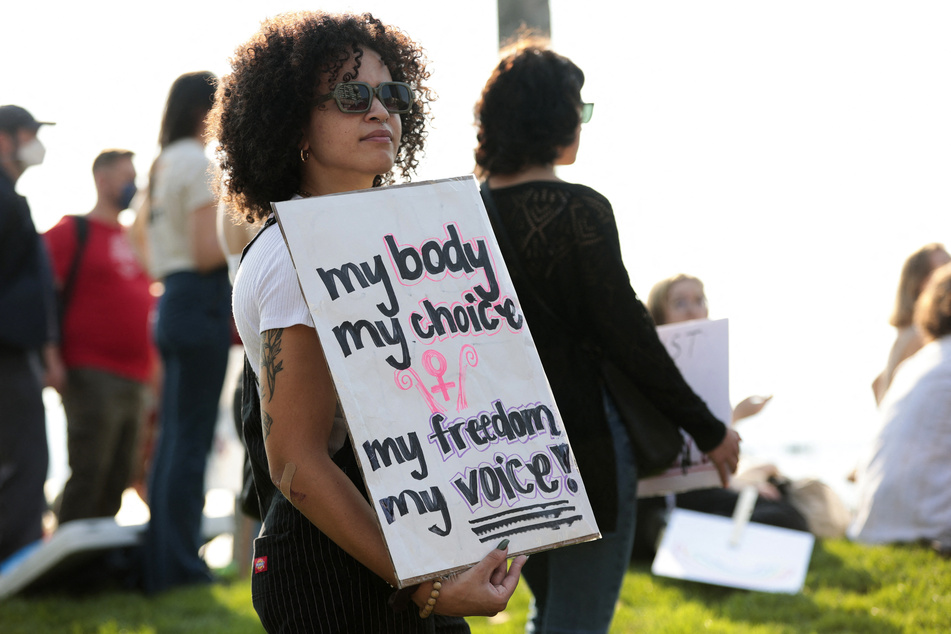 A woman holds a sign in support of reproductive freedom during the Seattle Defends Abortion Rights! rally and march on October 8, 2022.