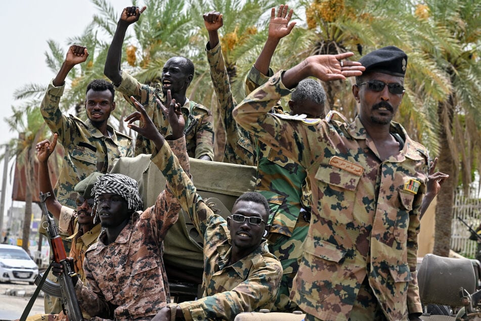 Members of Sudan's armed forces take part in a military parade held on the occasion of Army Day outside the Armed Forces Officers' Club in Port Sudan on August 14, 2024.