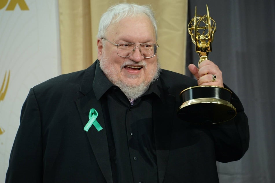 George R. R. Martin raises his 2015 Emmy Award for Outstanding Drama Series for the popular show Game of Thrones (archive image).