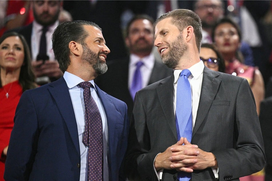 Donald Trump Jr. (L) and Eric Trump (R) attend the first day of the 2024 Republican National Convention at the Fiserv Forum in Milwaukee, Wisconsin on July 15, 2024.