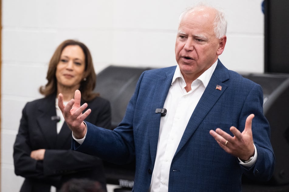 Kamala Harris (l.) listens to her running mate Tim Walz (r.) speaking during a visit at Liberty County High School in Hinesville, Georgia on August 28, 2024.