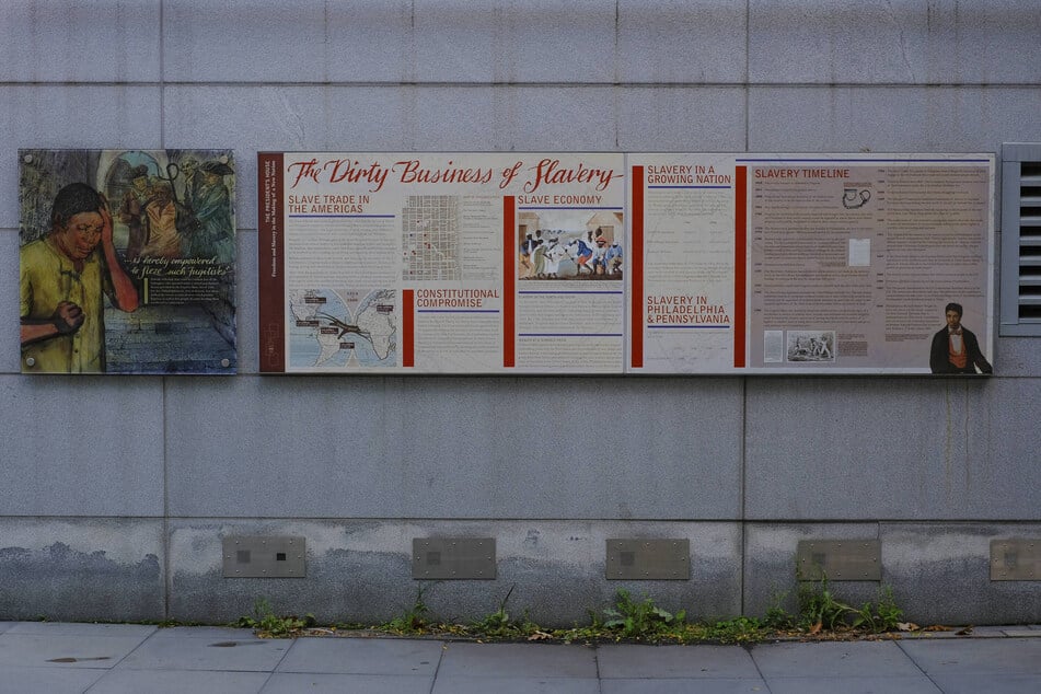 Signage about the history of slavery is displayed in an outdoor exhibit at Independence National Historical Park in Philadelphia, Pennsylvania.