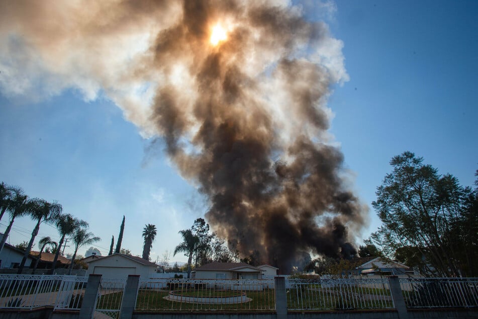 Smoke rises after a large explosion of fireworks went off in a residential neighborhood of Ontario.