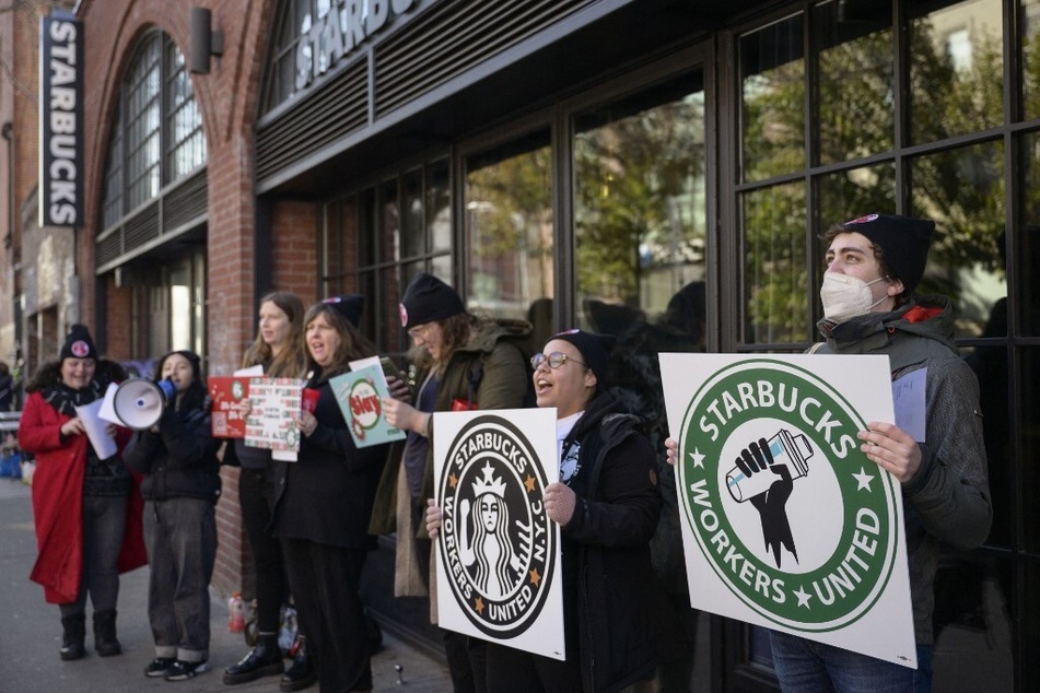 Starbucks workers strike outside a coffee shop in Brooklyn, New York, to protest the company's union busting.