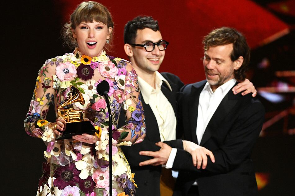 (From l. to r.) Taylor Swift, Jack Antonoff, and Aaron Dessner accept the Album of the Year award for Folklore at the 2021 Grammy Awards.