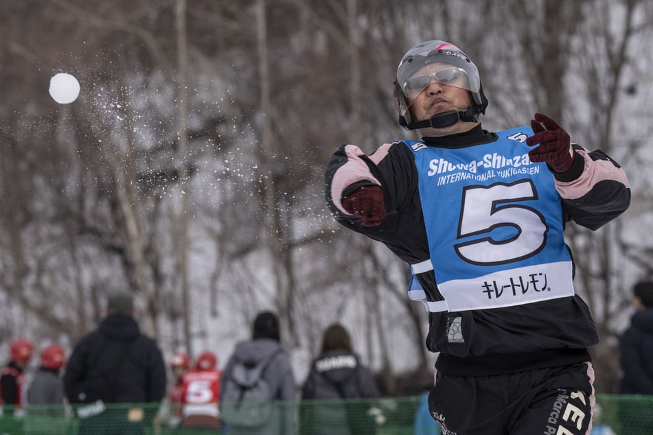 A player throws a snowball during the Showa-shinzan International Yukigassen competition in Sobetsu, Hokkaido prefecture, on February 21, 2026.