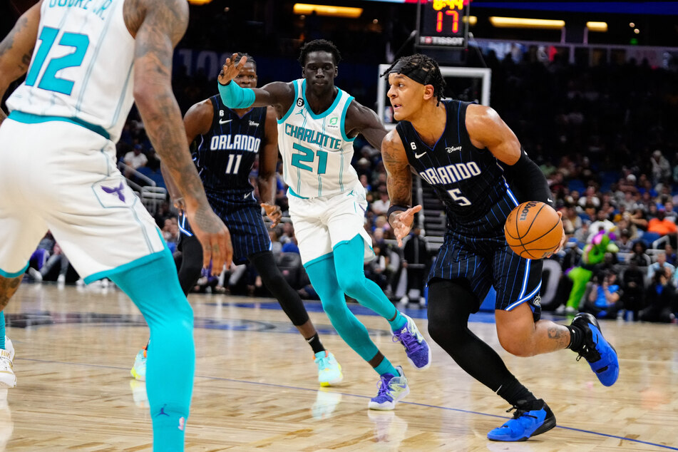 Orlando Magic forward Paolo Banchero dribbles the ball past Charlotte Hornets forward JT Thor during the second quarter at Amway Center.