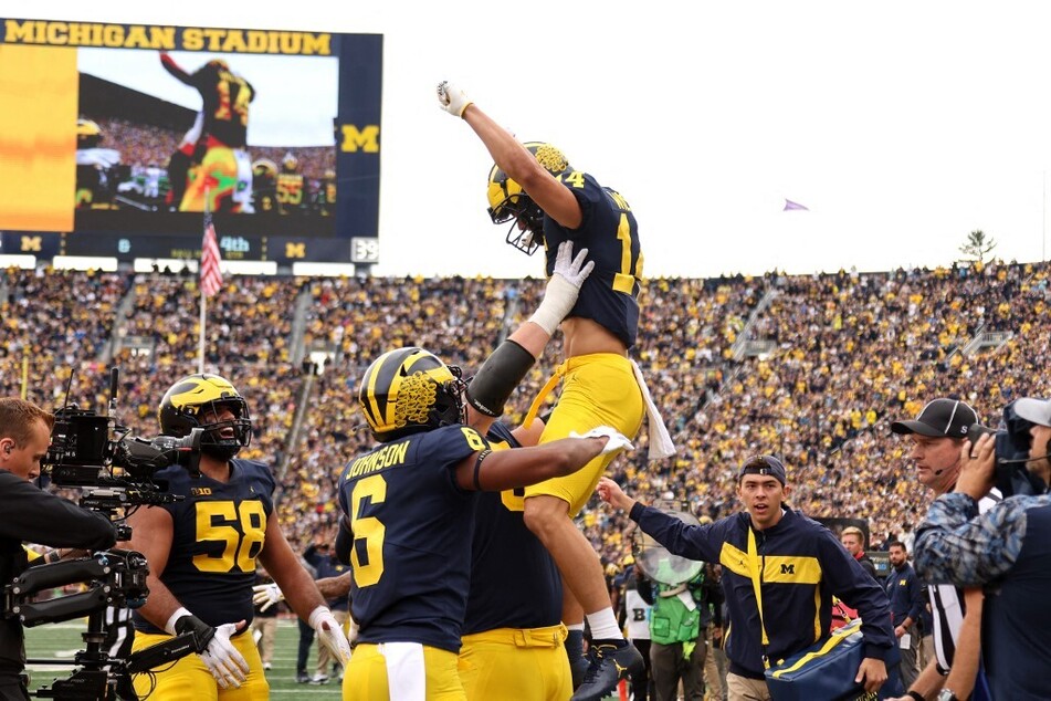 The Michigan Wolverines celebrate their fourth consecutive win of the season against fellow Big Ten opponent Maryland Terps.