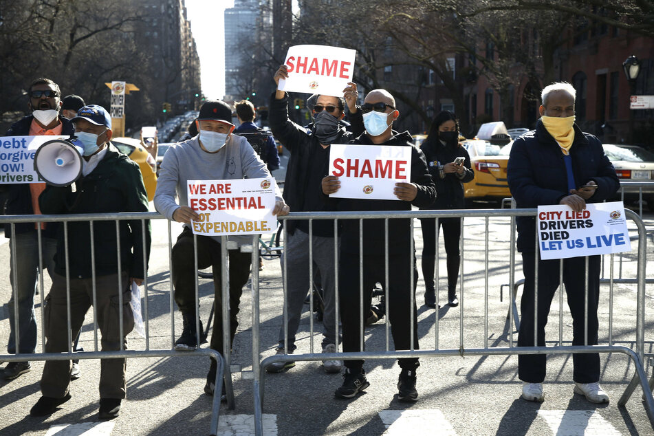 Taxi drivers have protested against the De Blasio debt restructuring proposal, citing that Mayor Bill de Blasio's debt restructuring deal does not go far enough and benefits financial institutions.