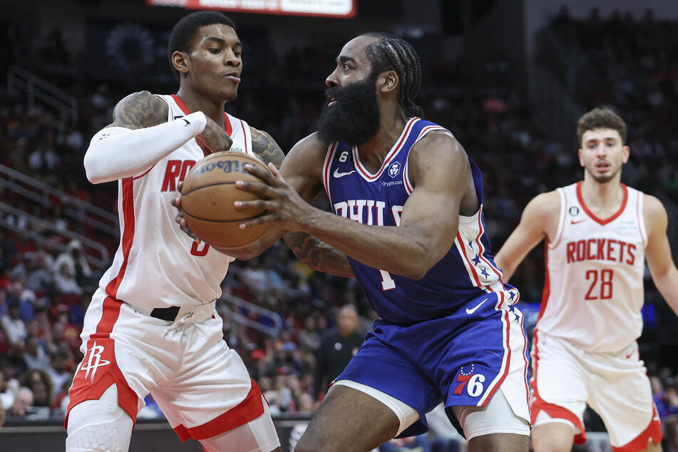 Philadelphia 76ers guard James Harden drives to the basket as Houston Rockets guard Kevin Porter Jr. defends during overtime at Toyota Center.