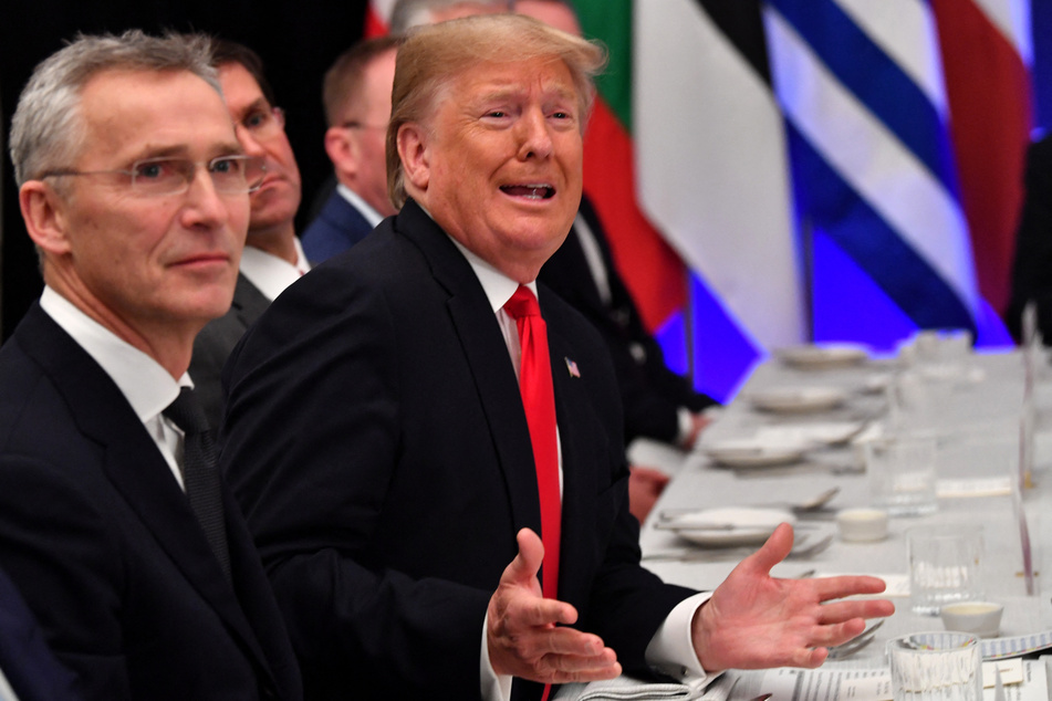 NATO Secretary General Jens Stoltenberg (L) looks on as then-US President Donald Trump (r.) gestures during a working lunch at the NATO summit at the Grove hotel in Watford, northeast of London on December 4, 2019.