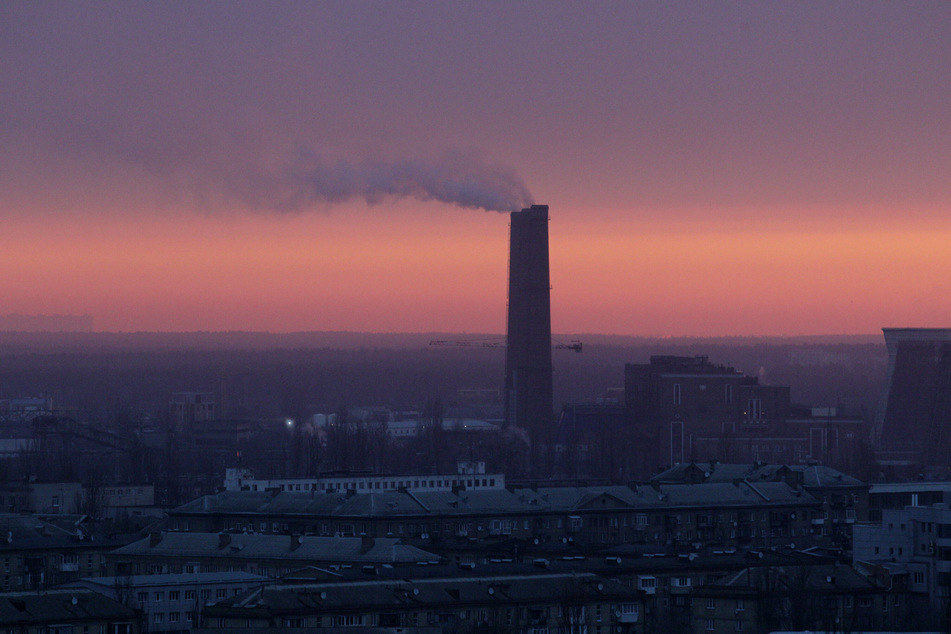 Smoke rises from a Kyiv high-rise at dawn on the second day of the Russian invasion.