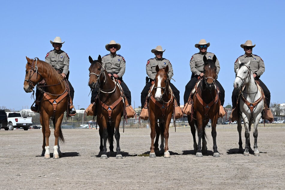 Members of the US Border Patrol listen as Vice President JD Vance speaks to the press as he tours the US-Mexico border at Eagle Pass, Texas, on Wednesday.