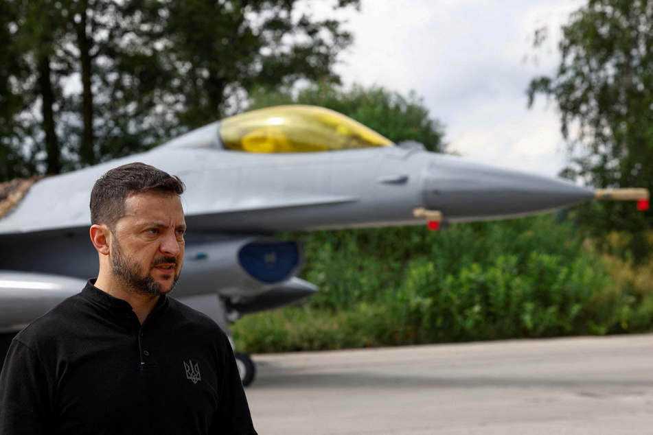 Ukraine's President Volodymyr Zelensky speaks to the media in a front of an F-16 fighting aircraft after marking the Day of the Ukrainian Air Forces.