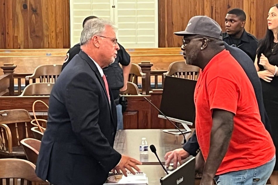 Hog Hammock resident and Sapelo Island descendant Maurice Bailey (r.) talks with McIntosh County Commission Chairman David Stevens, who voted to remove zoning restrictions in the historic community.