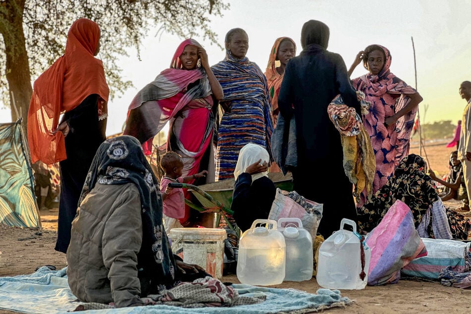 Displaced Sudanese people who fled El-Fasher after the city fell to the Rapid Support Forces, gather in the town of Tawila in Sudan's western Darfur region, on October 28, 2025.