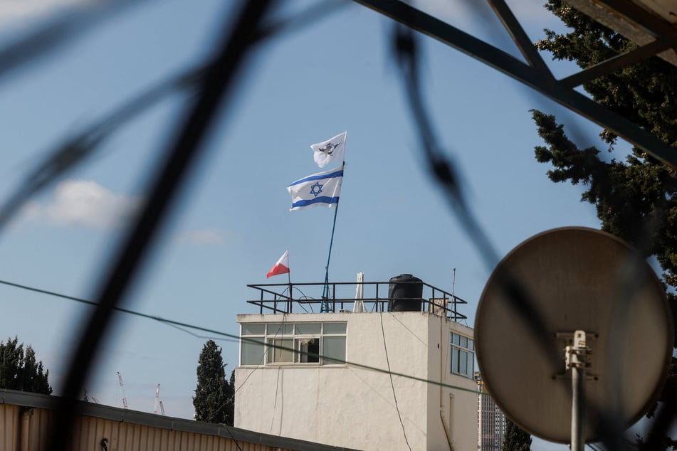 An Israeli flag flutters on top of a building of the East Jerusalem headquarters of UNRWA as it is dismantled by Israeli forces on January 20, 2026.
