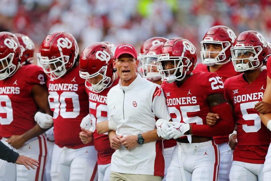 Head coach Brent Venables of the Oklahoma Sooners leads his team to the end zone before a game against the Kent State Golden Flashes at Gaylord Family Oklahoma Memorial Stadium.