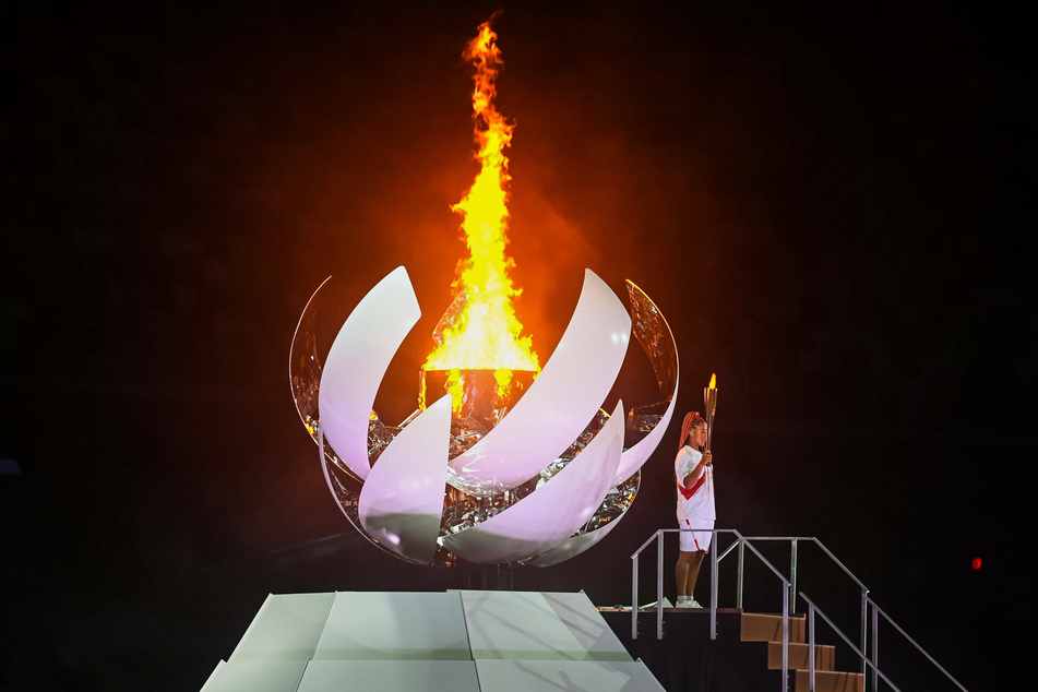 Tennis star Naomi Osaka lighting the Olympic cauldron.
