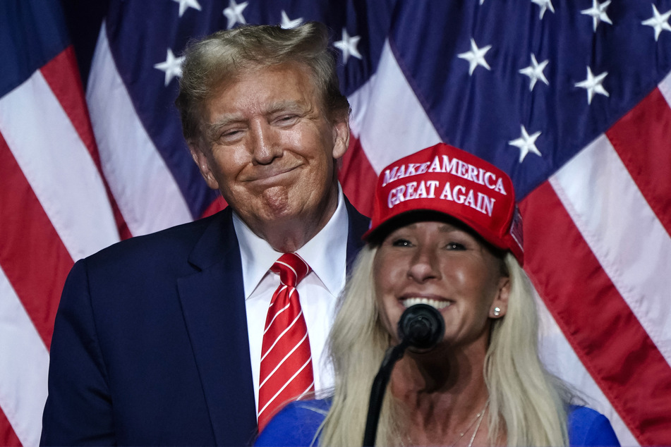 House Representative Marjorie Taylor Greene (r.) speaks alongside former US President and 2024 presidential hopeful Donald Trump (l.) at a campaign event in Rome, Georgia, on March 9, 2024.