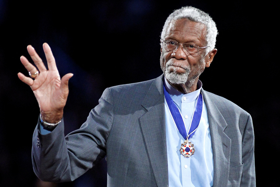 Boston Celtics legend Bill Russell stands with his Presidential Medal of Freedom during the 2011 NBA All-Star game in Los Angeles.