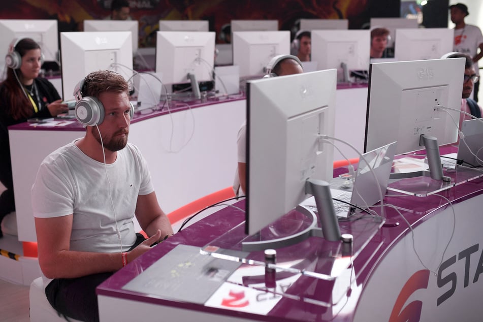 A gamer tests the cloud version of the classic game Doom at the stand of Google Stadia during the Gamescom video games trade fair in Germany.