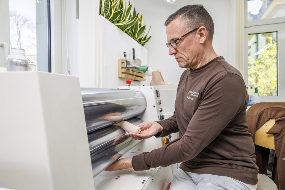 Silikontechniker Karsten Schubert (59) arbeitet an einer Walzmaschine.
