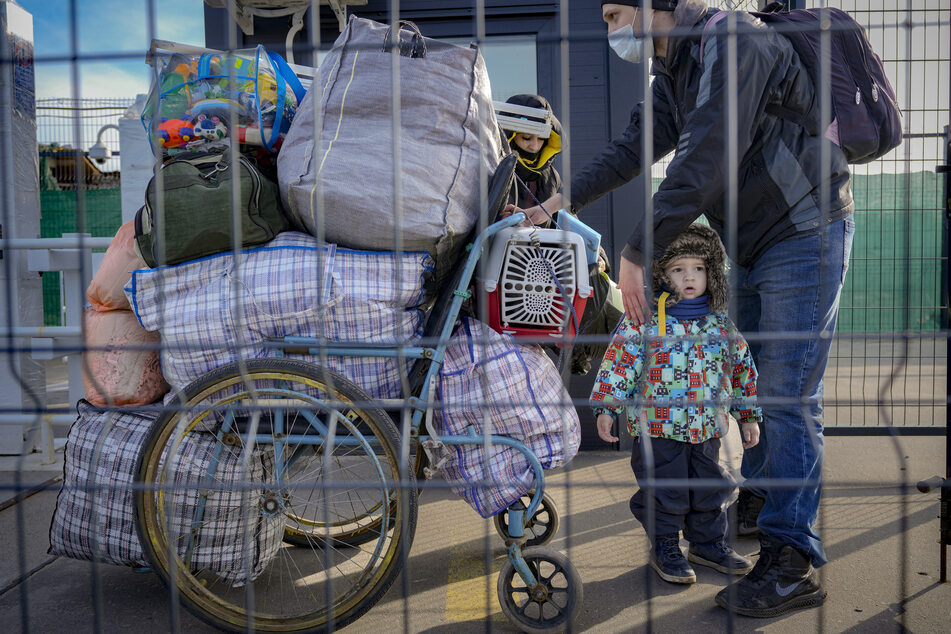 Eine Familie überquert in der Region Luhansk in der Ostukraine den einzigen täglich geöffneten Grenzübergang zwischen dem von prorussischen Separatisten kontrollierten Gebiet und den von der ukrainischen Regierung kontrollierten Gebieten in Stanytsia Luhanska.