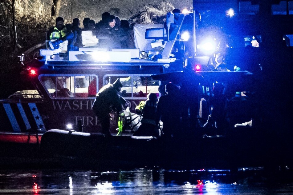 Emergency response units conduct search and rescue operations in the Potomac River near Ronald Reagan Washington Airport after a helicopter crashed into a plane on January 29, 2025.