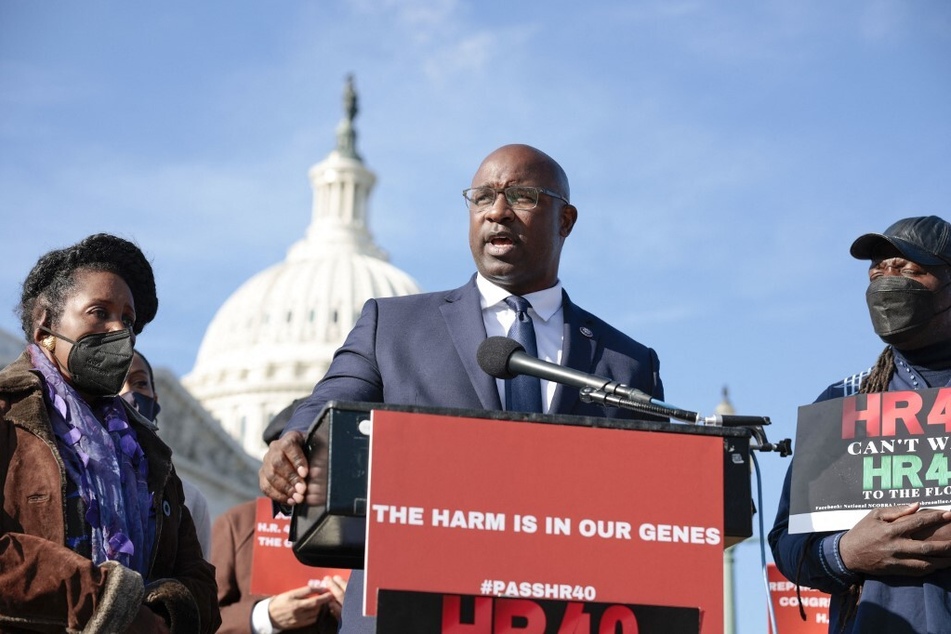 Rep. Jamaal Bowman (c.) speaks at a press conference on HR 40 alongside the bill's lead sponsor, Rep. Sheila Jackson Lee (l.), and Reparations United director Kamm Howard.