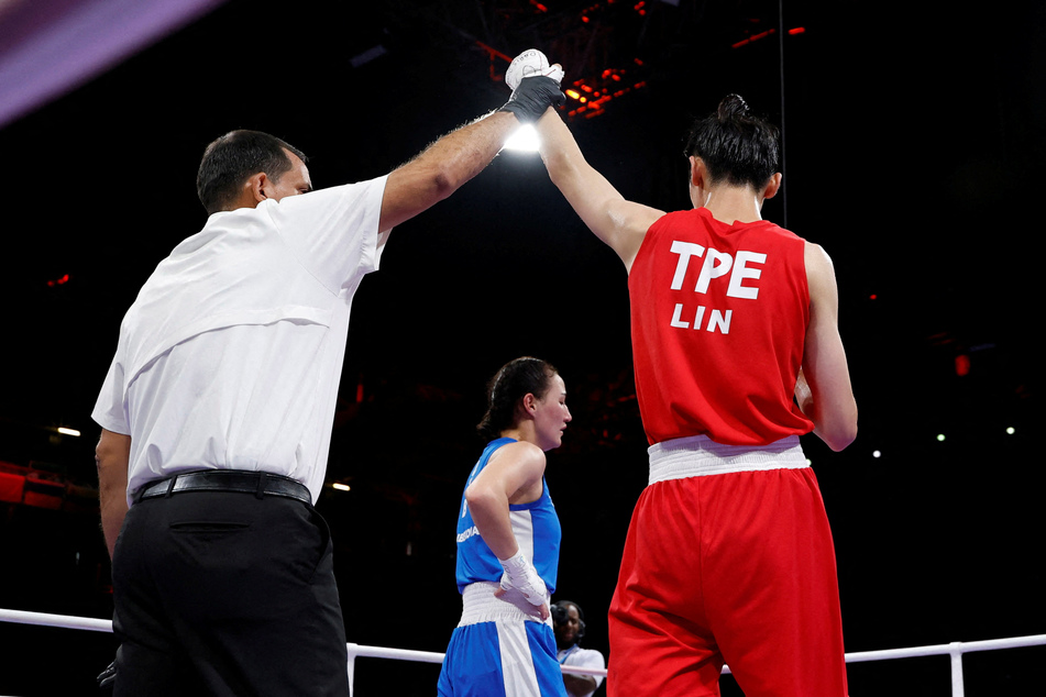 Lin Yu-ting of Taiwan has her hand raised after winning her fight against Sitora Turdibekova of Uzbekistan.