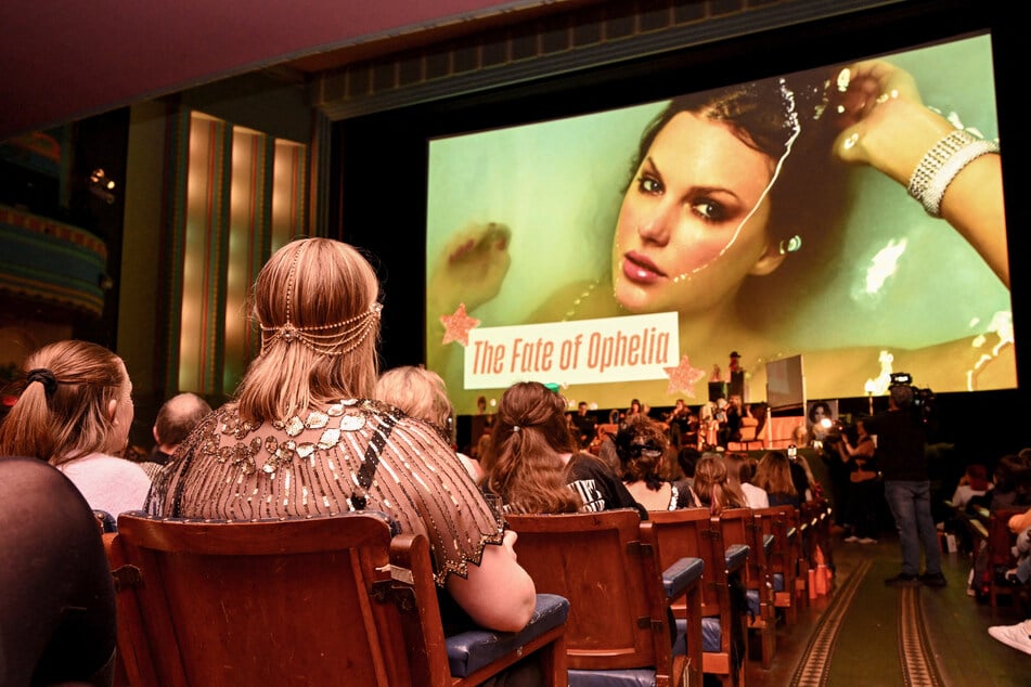 Taylor Swift fans listen to a song during a listening event for Swift's new album The Life of a Showgirl at the Astor Theatre in Melbourne on October 3, 2025.
