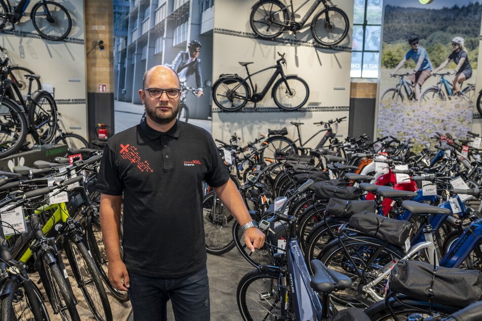 Viel zu eng: Filialleiter Denny Haase (33) möchte mit "Fahrrad XXL" die Markthalle verlassen.