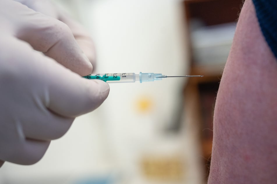 Ein Arzt impft in einer Hausarztpraxis mit dem Impfstoff von Pfizer/Biontech.
