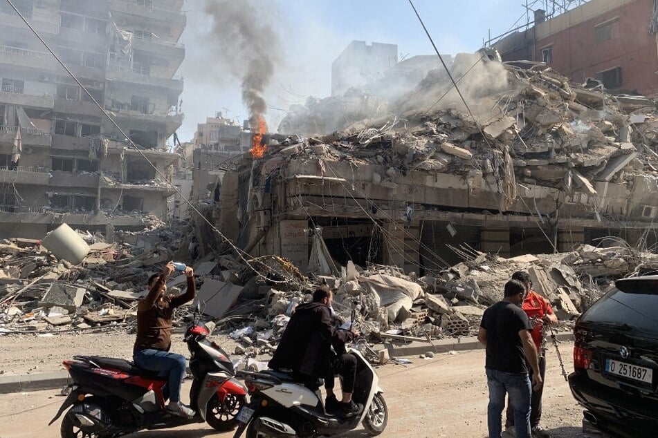 Lebanese people check the devastation in the aftermath of Israeli strikes in the neighborhood of Haret Hreik in Beirut's southern suburbs on November 1, 2024.