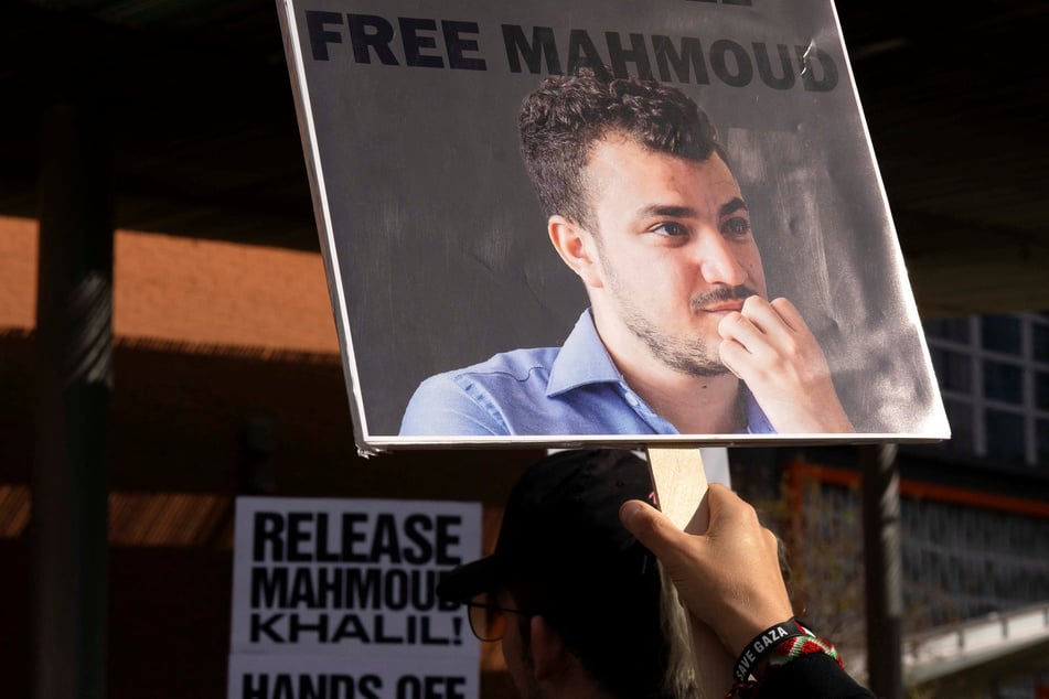 A demonstrator wears a bracelet reading "Save Gaza" while carrying a sign reading "Free Mahmoud" during a protest against the ICE detention of Mahmoud Khalil, near Arizona State University in Phoenix on March 15, 2025.