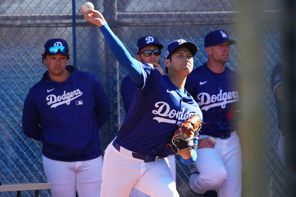 Los Angeles Dodgers two-way player Shohei Ohtani throws during a Spring Training workout at Camelback Ranch in Glendale, Arizona.