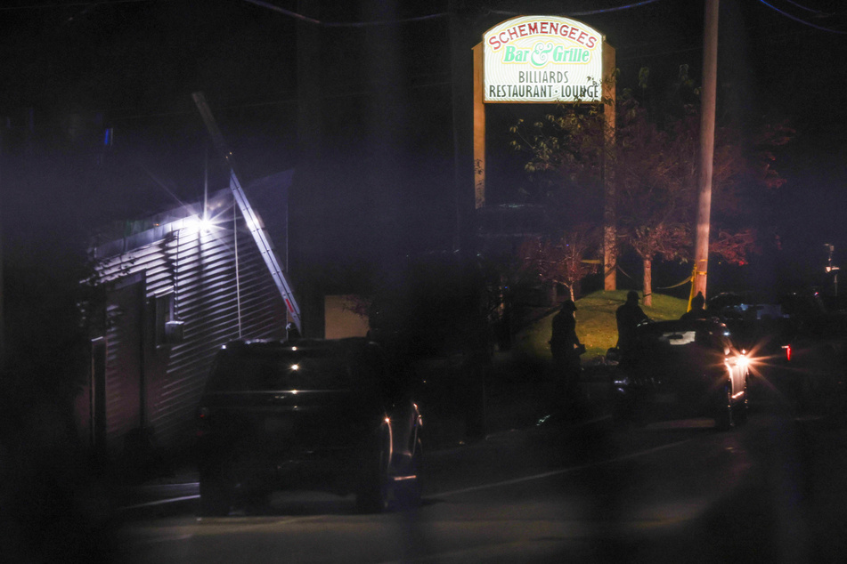 Law enforcement personnel work at the Schemengees Bar &amp; Grille Restaurant after deadly mass shootings in Lewiston, Maine.