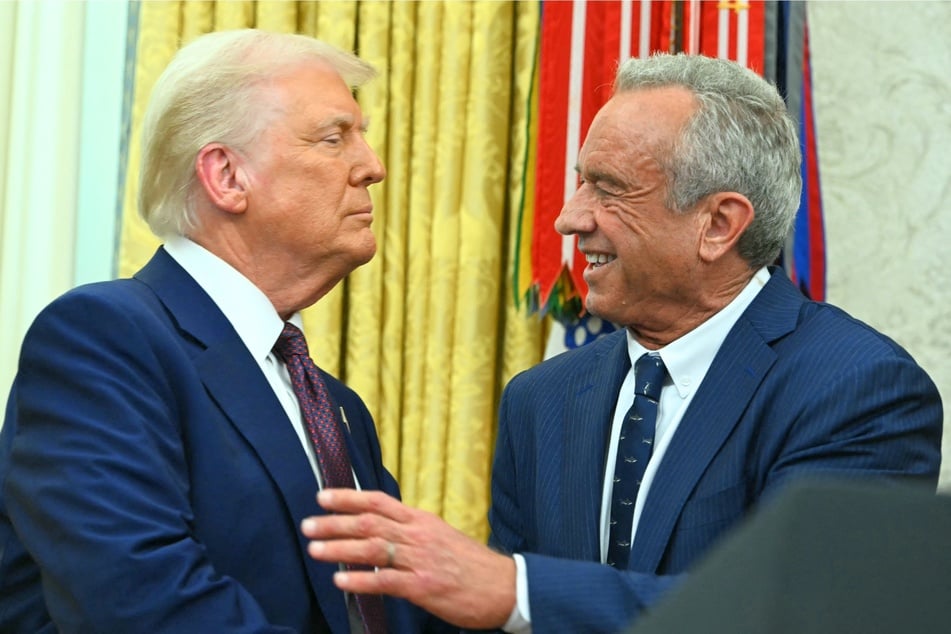 In a recent social media post, Robert F. Kennedy Jr. (r.) revealed he won't be running for president in 2028 because of his "loyalty" to Donald Trump (l.)