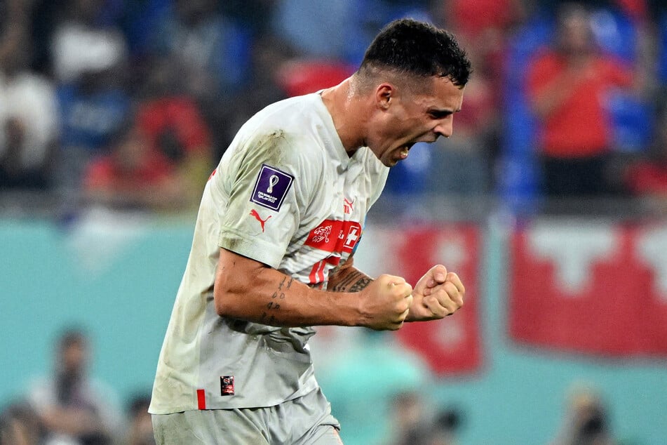 Switzerland and Arsenal midfielder Granit Xhaka celebrates his team's qualification to the last 16.