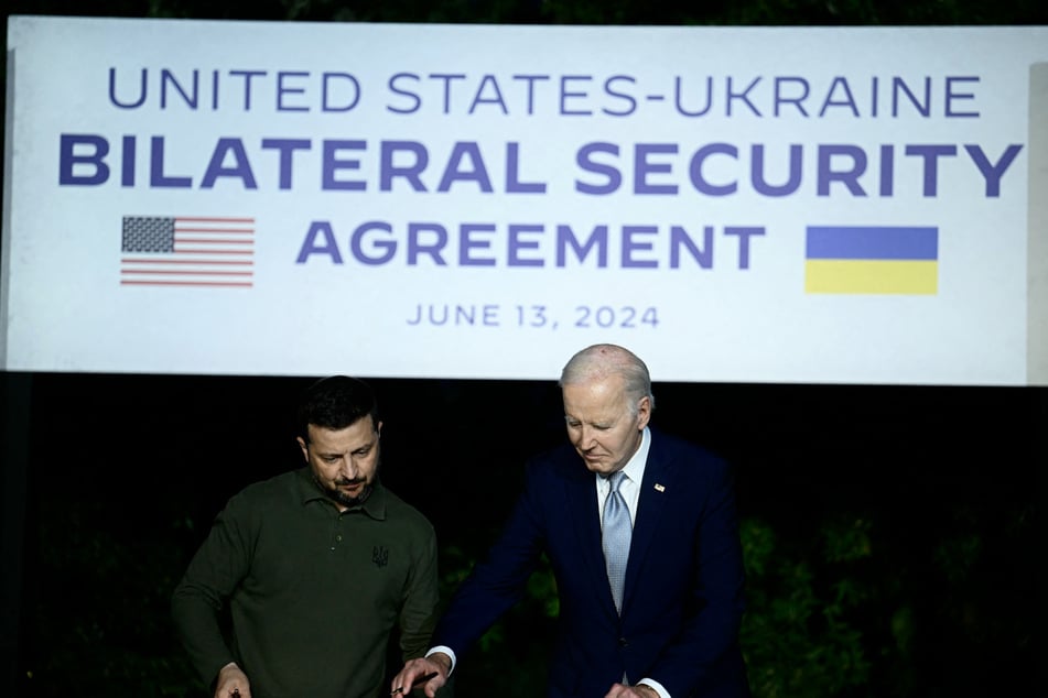 Ukrainian President Volodymyr Zelensky (l.) and US President Joe Biden sign a bilateral security agreement during a press conference at the Masseria San Domenico on the sidelines of the G7 Summit.