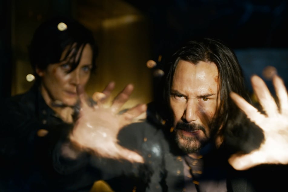 Keanu Reeves and Carrie-Ann Moss return as Neo and Trinity in The Matrix Resurrections.