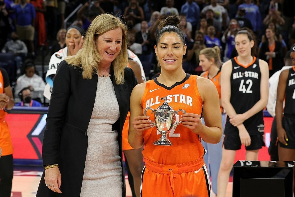 Kelsey Plum of Team Wilson is presented with the MVP trophy during the 2022 AT&amp;T WNBA All-Star Game.