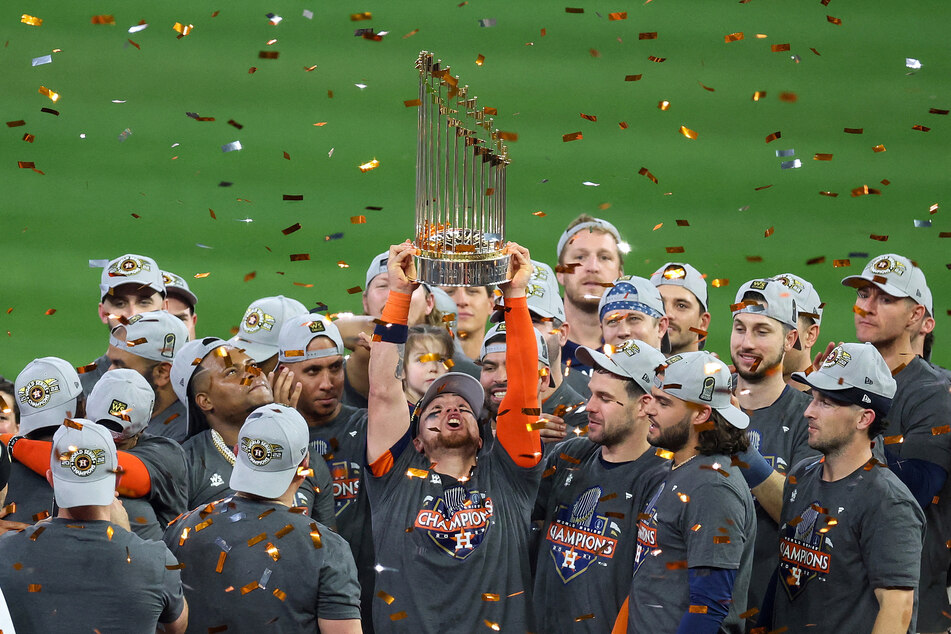 The Houston Astros hold up the World Series trophy after defeating the Philadelphia Phillies in game 6 and winning the 2022 World Series at Minute Maid Park.