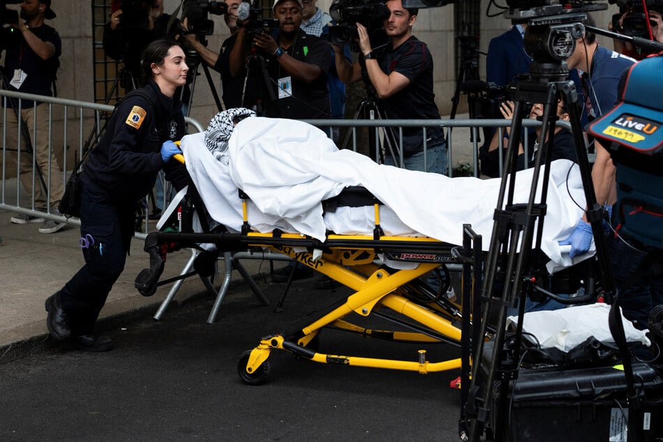 A pro-Palestinian demonstrator is transported on a stretcher from Butler Library on the Columbia University campus in New York on May 7, 2025.