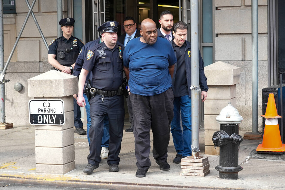 Frank Robert James (c.), the gunman who open fired with a handgun while on a packed Brooklyn train last April, has pled guilty to terrorism charges.