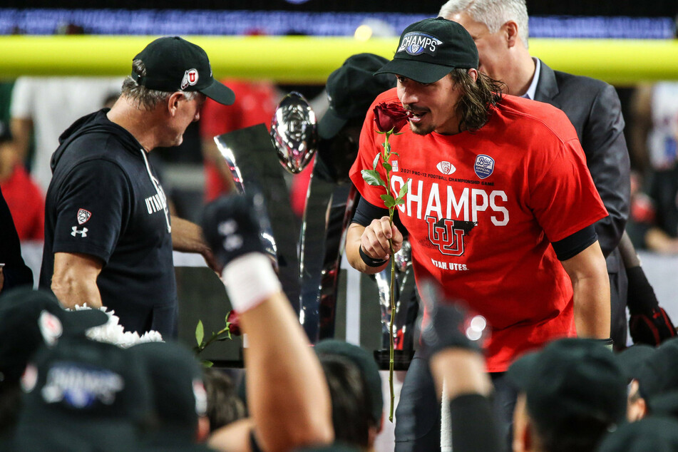 Utah Utes head coach Kyle Whittingham (l) and quarterback Cameron Rising (r) stand on a stage at the conclusion of the PAC-12 Football Championship Game.